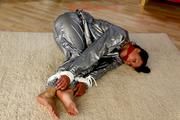 Alina tied and gagged in a shiny silver PVC saunasuit