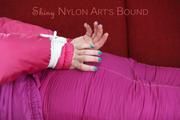 Jill tied and gagged on a red sofa wearing a sexy pink down combination (Pics)