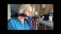 Pia tied and gagged on a chair wearing a shiny green downsuit (Video)