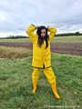 Miss Amira on the road in a Frisian mink, yellow rain dungarees and rubber boots