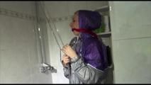 Mara wearing a sexy purple/silver pvc combination tied and gagged on a shower (Video)