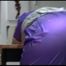 Jill tied and gagged on a table wearing a shiny purple/silver PVC sauna Suit (Video)