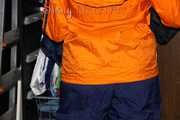 Sexy Lucy wearing a blue shiny nylon rain pants and an orange rain jacket sorting shiny nylon shorts (Pics)