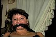33 YEAR OLD AMERICAN INDIAN TRISH IS HANDCUFFED, MOUTH STUFFED, CLEAVE GAGGED, CHAIR TIED, BALL-GAGGED, HANDGAGGED WEARING LINGERIE, GARTER BELT, NYLONS & HEELS (D70-10)