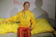 Watching Sandra wearing supersexy shiny nylon rainwear in yellow and orange preparing her bed and lolling in it with this shiny rainwear (Pics)