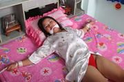 Asian Girl is Tied Spread on the Bed