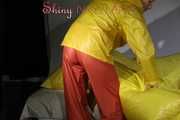 Watching Sandra wearing supersexy shiny nylon rainwear in yellow and orange preparing her bed and lolling in it with this shiny rainwear (Pics)