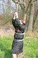 Jill tied, gagged and hooded on a tree outdoor wearing a shiny black down jacket (Pics)