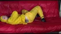 ***MARA*** ties and gagges with cuffs on the sofa wearing a supersexy oldschool yellow rain suit with hood (Video)