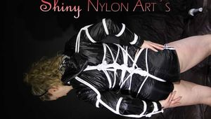 Sophie being tied with ropes in a special way wearing a sexy black shiny nylon shorts and a black shiny nylon rain jacket (Pics)