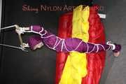 Watching sexy Sonja wearing a supersexy purple shiny nylon rainwear combination being tied and gagged overhead with ropes and a clothgag (Pics)