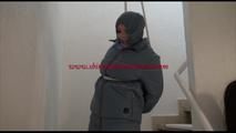 Jill tied, gagged and hooded in an stairway wearing a sexy shiny grey downwear (Video)