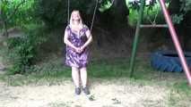 Miri cuffed on a swing