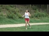 Enni jogs wearing red shiny nylon shorts and a top (Video)