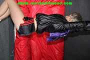 Sexy Sonja wearing a sexy black shiny nylon shorts and a shiny nylon rain jacket being tied and gagged overhead with ropes (Pics)