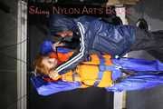 See Ronja tied and gagged by Stella in shiny nylon Rainwear and a Life Vest!