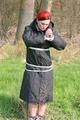 Jill tied, gagged and hooded on a tree outdoor wearing a shiny black down jacket (Pics)