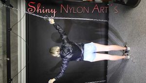Watching sexy Sonja being tied and gagged overhead with ropes and a clothgag wearing a sexy shiny nylon shorts and a rainjacket (Pics)