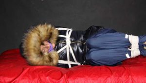 Sonja being tied, gagged and hooded on a shiny nylon bed with ropes and a clothgag wearing a supersexy shiny nylon rain pants and a black down jacket with fur (Pics)