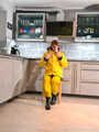 Miss Lara in nylon rain suit and yellow rain dungarees is bound and gagged