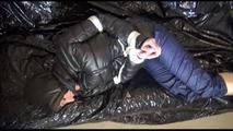 Mara tied, gagged and hooded on a sexy black covered sofa wearing a supersexy black down jacket and rain pants (Video)