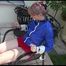 Mara tied and gagged on a chair outdoor wearing a sexy shiny nylon shorts and a rain jacket (Video)
