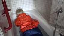 Sexy Sonja taking a bath in the bath tub wearing a sexy shiny nylon down jacket and a rain pants (Video)