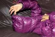 Watching sexy Sandra wearing a black rain pants and a purple down jacket playing with the closed hood (Pics)