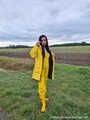 Miss Amira on the road in a Frisian mink, yellow rain dungarees and rubber boots