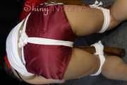 Watching sexy Sandra being tied and gagged with ropes and a clothgag on a stool wearing a sexy darkred shiny nylon shorts and a white top (Pics)