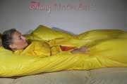 Watching Sandra wearing supersexy shiny nylon rainwear in yellow and orange preparing her bed and lolling in it with this shiny rainwear (Pics)