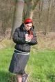 Jill tied, gagged and hooded on a tree outdoor wearing a shiny black down jacket (Pics)