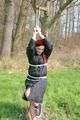 Jill tied, gagged and hooded on a tree outdoor wearing a shiny black down jacket (Pics)