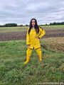 Miss Amira on the road in a Frisian mink, yellow rain dungarees and rubber boots