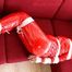Julia tied and gagged on the sofa in a shiny red PVC Sauna suit (Pics)