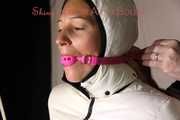 Watching sexy Sandra wearing a sexy pink shiny nylon rainpants and a special white down jacket being tied and gagged and hooded with ropes and a ballgag on a bar (Pics)