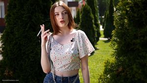 18 y.o. Sasha is smoking two white 120mm cigarettes outdoors