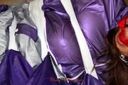 Alina tied, hodded and gagged on the floor in an purple/silver shiny PVC suit (Pics)