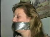43 YEAR OLD WAITRESS IS TAPE BALL-TIED, TAPE HOG-TIED, BAREFOOT, TOE-TIED & WRAP TAPE GAGGED (D62-10)