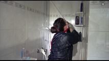 Jill tied and gagged taking a shower wearing sexy shiny nylon shorts and a rain jacket (Video)