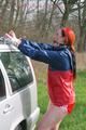 Jill tied and gagged outdoor on a car wearing a sexy red shiny nylon shorts and an oldschool rain jacket (Pics)