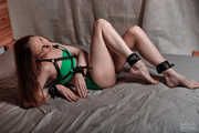 Foots with ankle shackles and harness in green lingerie