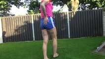 Watch Maly in her shiny nylon Shorts enjoying the warm Weather in the Garden