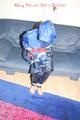 Jill tied, gagged and hooded wearing shiny nylon rainwear (Pics)