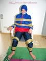 Katharina tied by using tape, gagged and hooded on a chair wearing sexy red/blue rainwear (Pics)