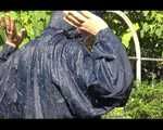 Mara wearing only a hot rain jacket and rubber boots lingering in the garden taking a shower (Video)