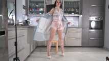 Miss Amira in transparent sauna suite covering with a Ilse Jacobsen raincoat