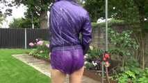 Watching Aiyana wearing a sexy purple shiny nylon shorts and a purple rain jacket while taking a shower in the garden (Video)