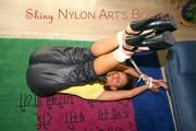 Stella tied and gagged on the floor wearing a shiny nylon rain pants (Pics)