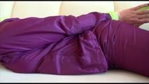 Mara tied and gagged on a sofa wearing a shiny purple rainwear combination (Video) 